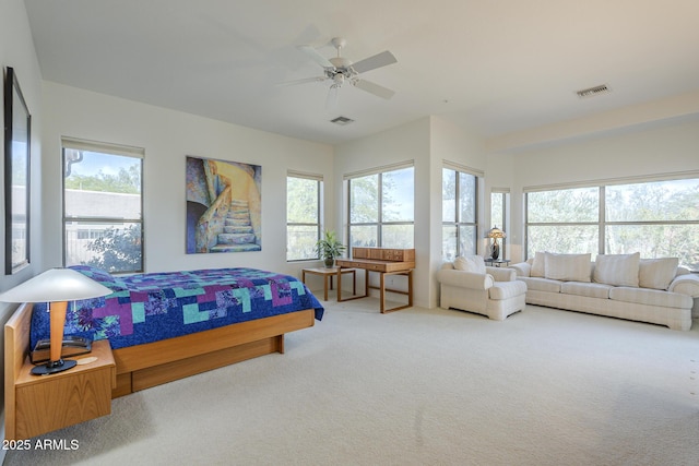 bedroom featuring carpet, visible vents, and multiple windows