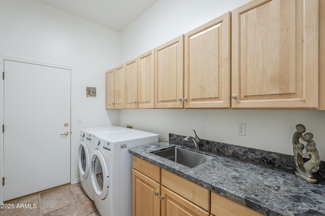 clothes washing area featuring cabinet space, washer and clothes dryer, and a sink