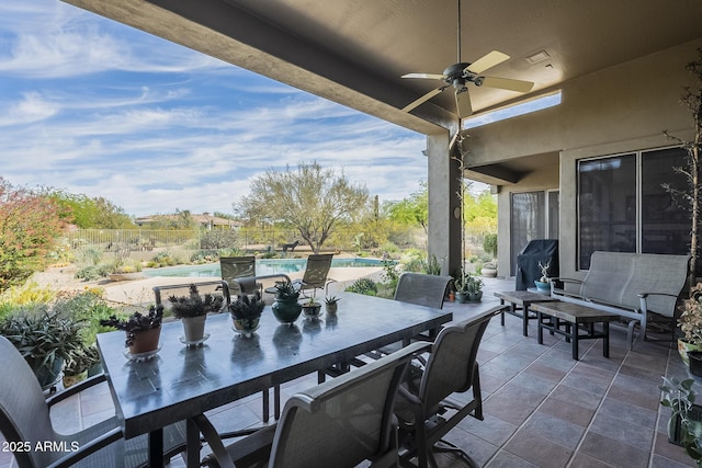 view of patio featuring ceiling fan, outdoor dining space, and an outdoor pool