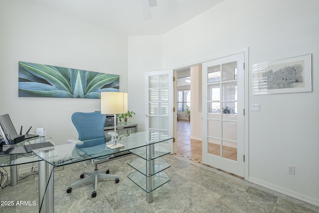 office featuring baseboards and ceiling fan