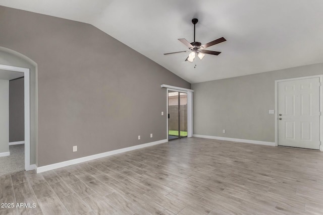 8720 W Willowbrook Dr, Peoria, AZ 85382 - spare room featuring vaulted ceiling, ceiling fan, light wood-style flooring, and arched walkways