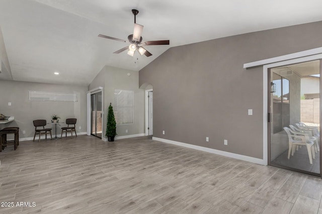 8720 W Willowbrook Dr, Peoria, AZ 85382 - unfurnished living room featuring light wood-style flooring, ceiling fan, lofted ceiling, recessed lighting, and arched walkways