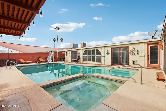 view of pool with a fenced in pool, a water slide, an in ground hot tub, and a patio area