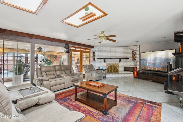 living room with tile patterned flooring, a healthy amount of sunlight, and a ceiling fan