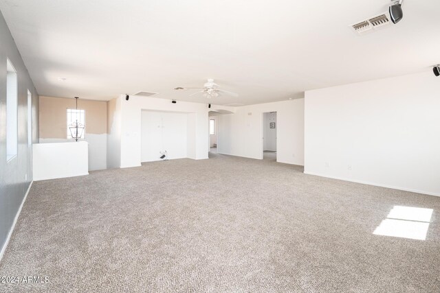 unfurnished living room featuring ceiling fan and carpet flooring