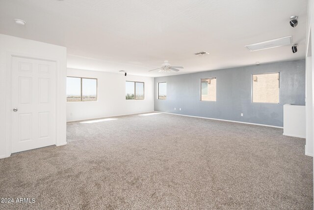 carpeted spare room with ceiling fan