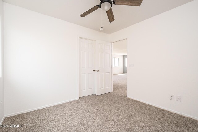 carpeted empty room with ceiling fan