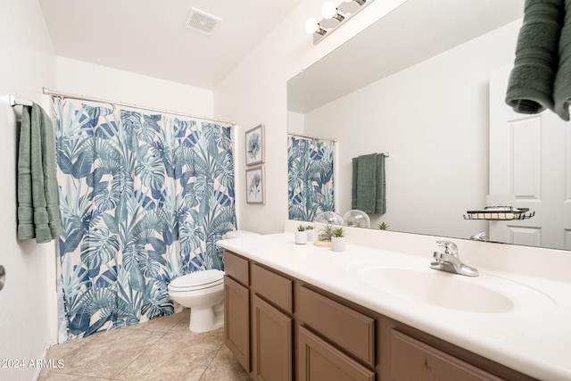 bathroom with vanity, tile patterned flooring, and toilet