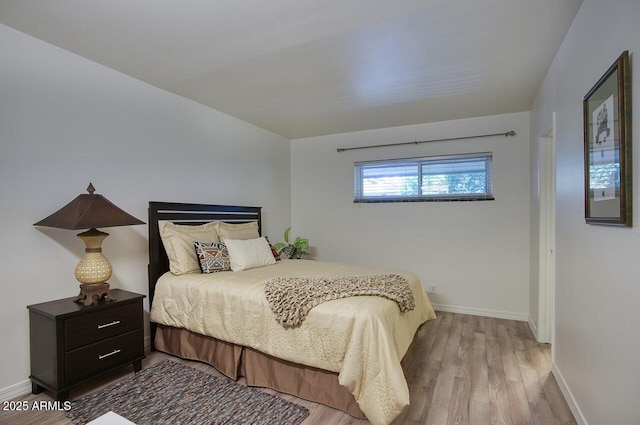 1107 W Osborn Rd Unit 213, Phoenix, AZ 85013 - bedroom with wood finished floors and baseboards