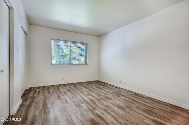 1107 W Osborn Rd Unit 213, Phoenix, AZ 85013 - unfurnished bedroom with wood finished floors and a closet