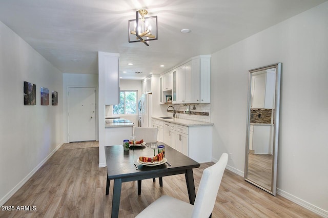 1107 W Osborn Rd Unit 213, Phoenix, AZ 85013 - dining space featuring light wood finished floors, a chandelier, and recessed lighting