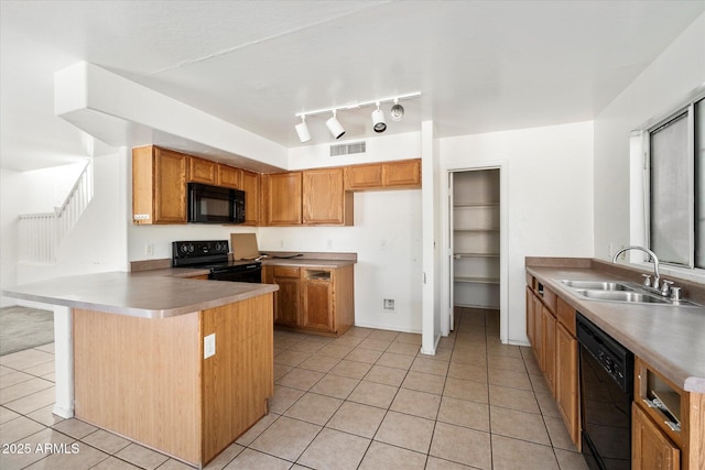 kitchen with sink, light tile patterned floors, black appliances, and kitchen peninsula