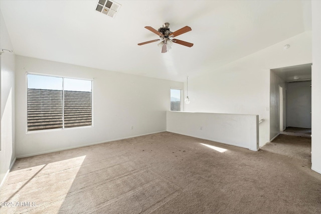 carpeted empty room featuring ceiling fan and lofted ceiling