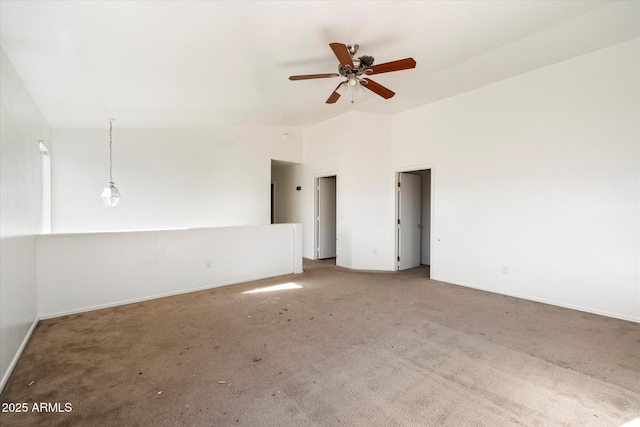 empty room with ceiling fan, lofted ceiling, and carpet