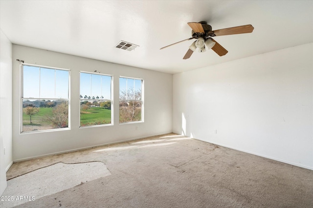 spare room featuring carpet and ceiling fan