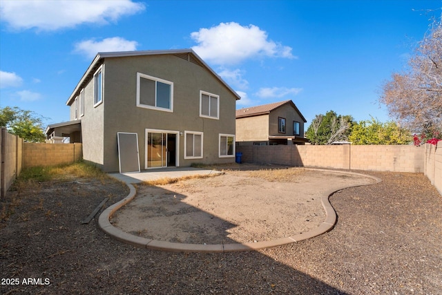 back of property with a patio