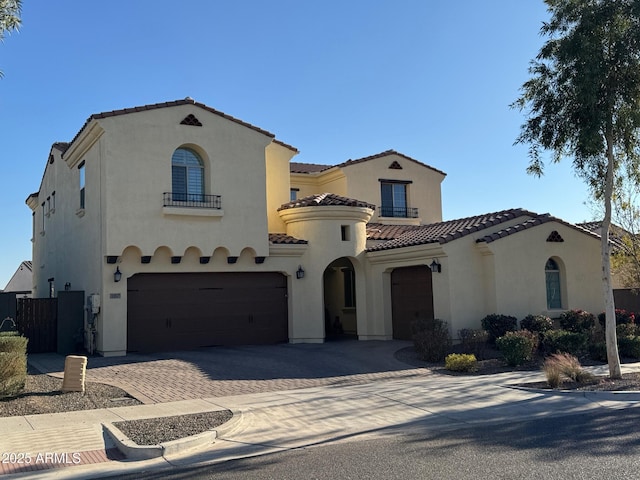 mediterranean / spanish home with a garage