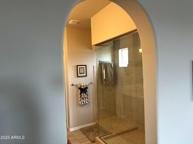 bathroom with a shower with door