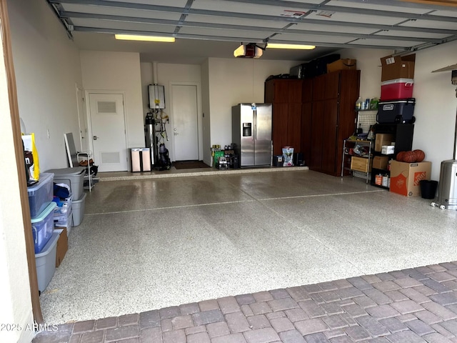 garage featuring a garage door opener and stainless steel fridge