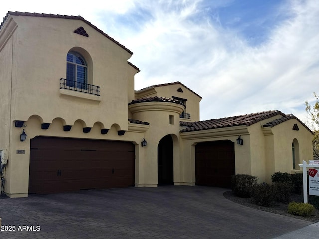 mediterranean / spanish house with a garage