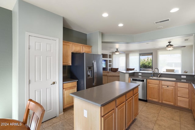 kitchen featuring stainless steel appliances, ceiling fan, sink, a center island, and light tile patterned flooring