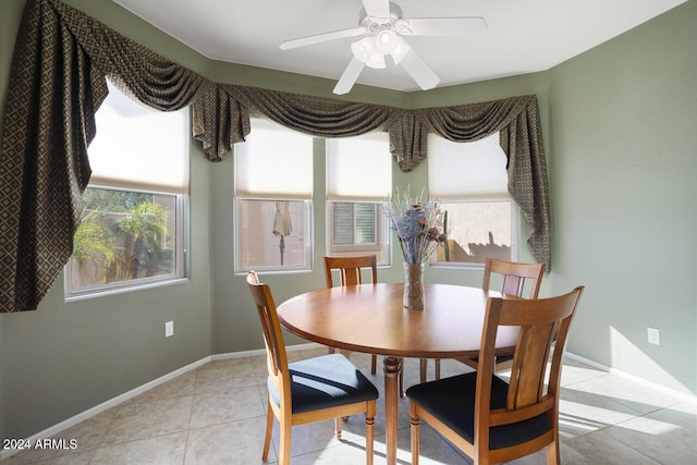 tiled dining area with ceiling fan