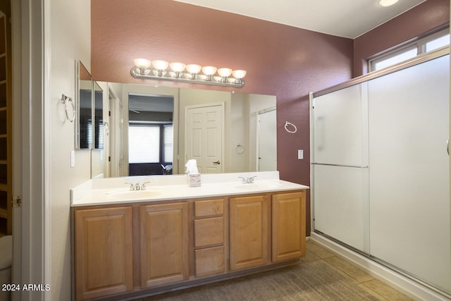 bathroom with tile patterned floors, vanity, and walk in shower