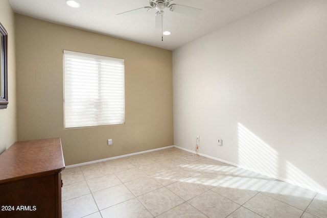 tiled empty room featuring ceiling fan