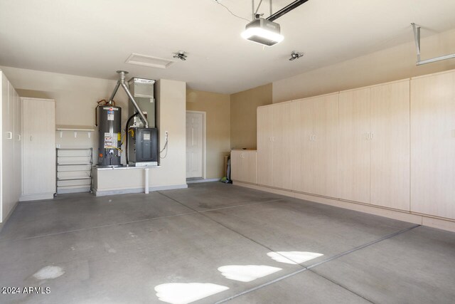 garage with a garage door opener and water heater