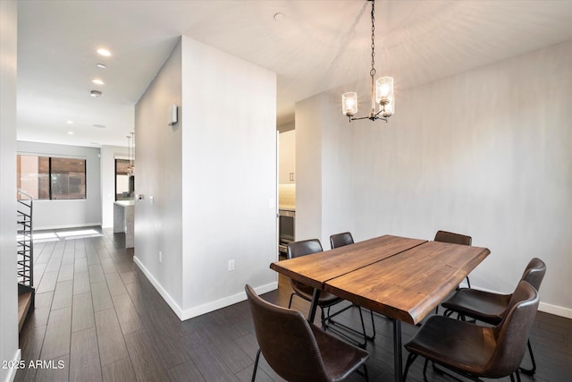 dining room featuring an inviting chandelier and dark wood-type flooring