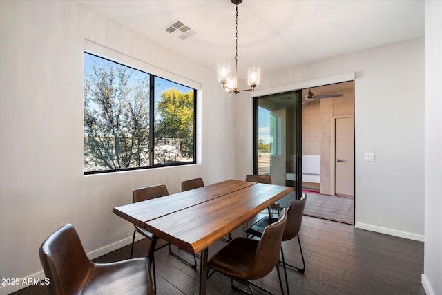 dining room featuring an inviting chandelier and dark hardwood / wood-style floors