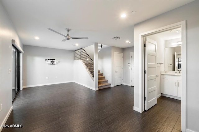 interior space with dark wood-type flooring, sink, and ceiling fan