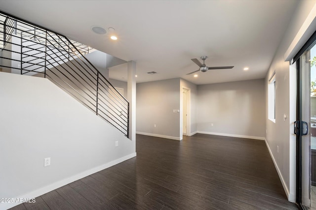 unfurnished living room with dark hardwood / wood-style floors and ceiling fan