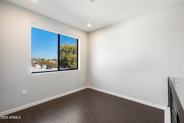 spare room with dark wood-type flooring