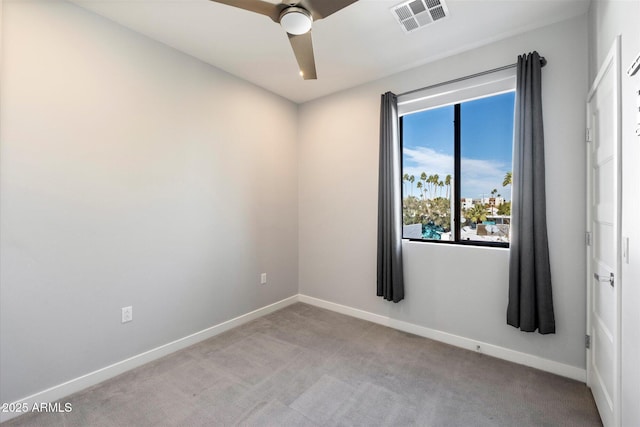 spare room with light carpet and ceiling fan