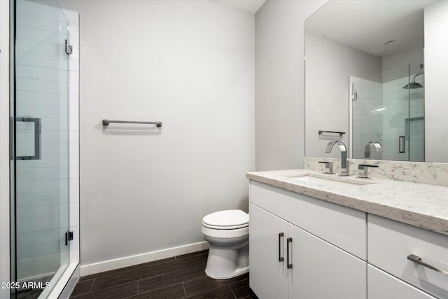 bathroom with vanity, walk in shower, and toilet