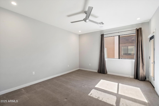 carpeted spare room with ceiling fan