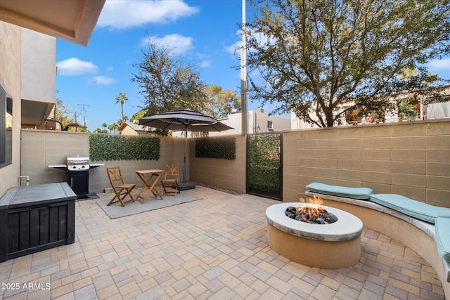 view of patio featuring area for grilling and a fire pit