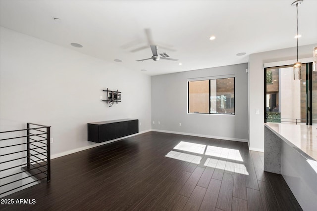 interior space with ceiling fan and dark hardwood / wood-style flooring