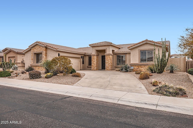 view of front of home featuring stucco siding, driveway, stone siding, a garage, and a tiled roof