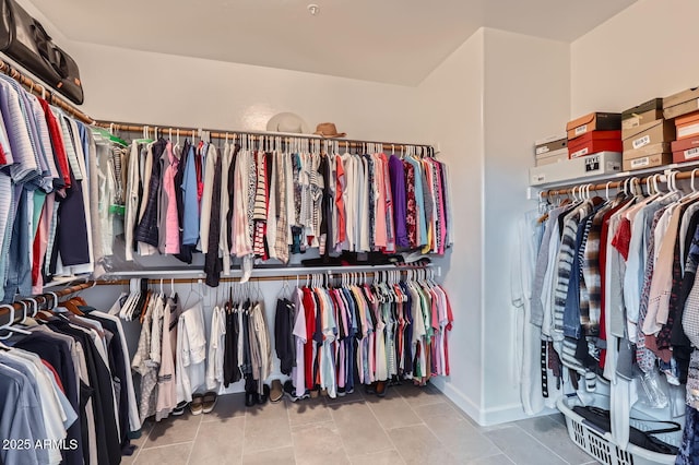 spacious closet with light tile patterned flooring