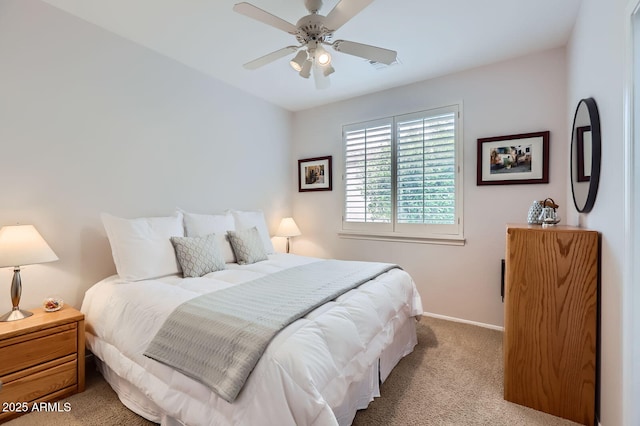 carpeted bedroom with visible vents, baseboards, and a ceiling fan