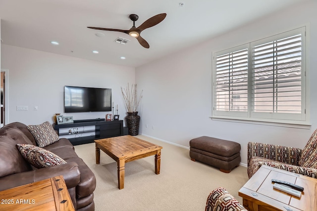 carpeted living area featuring recessed lighting, visible vents, baseboards, and a ceiling fan