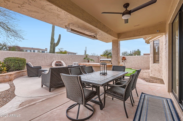 view of patio featuring outdoor dining area, a fenced backyard, and ceiling fan