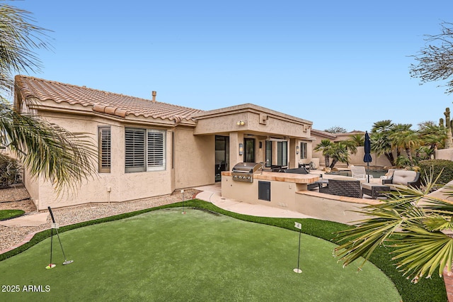 rear view of house featuring exterior kitchen, a patio area, an outdoor living space, and stucco siding