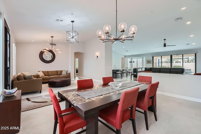 dining area featuring arched walkways, visible vents, ceiling fan with notable chandelier, and recessed lighting