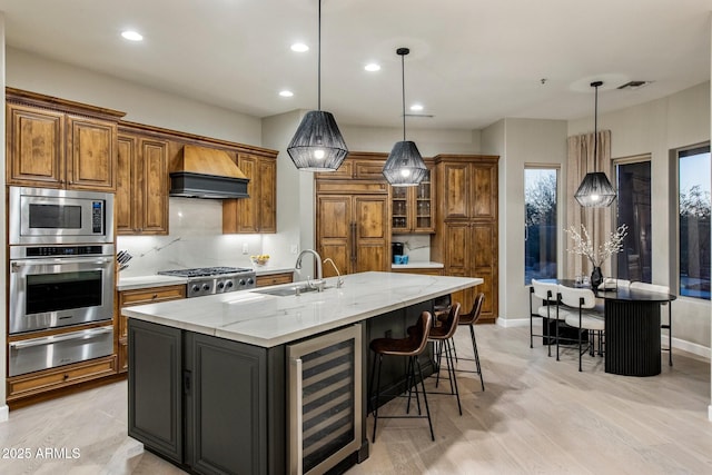 kitchen with wine cooler, brown cabinets, custom exhaust hood, and built in appliances