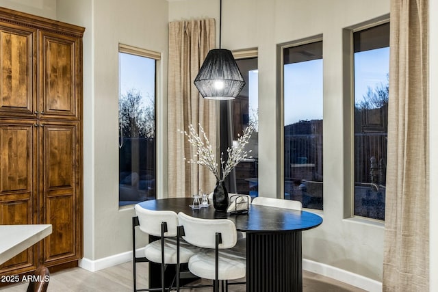 dining room featuring light wood-style floors and baseboards