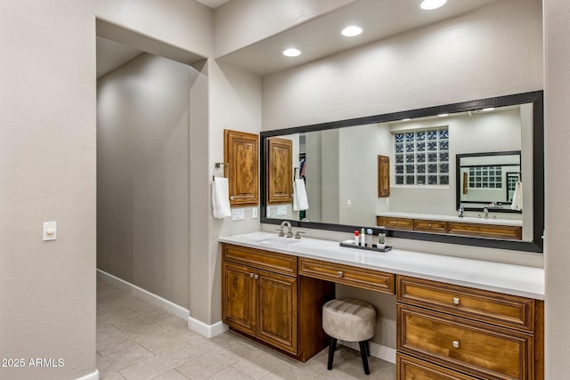 bathroom with recessed lighting, vanity, and baseboards