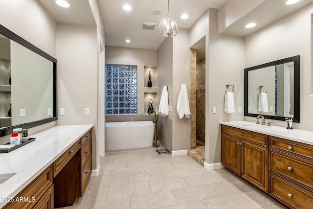 full bath with a tub to relax in, recessed lighting, two vanities, a sink, and walk in shower